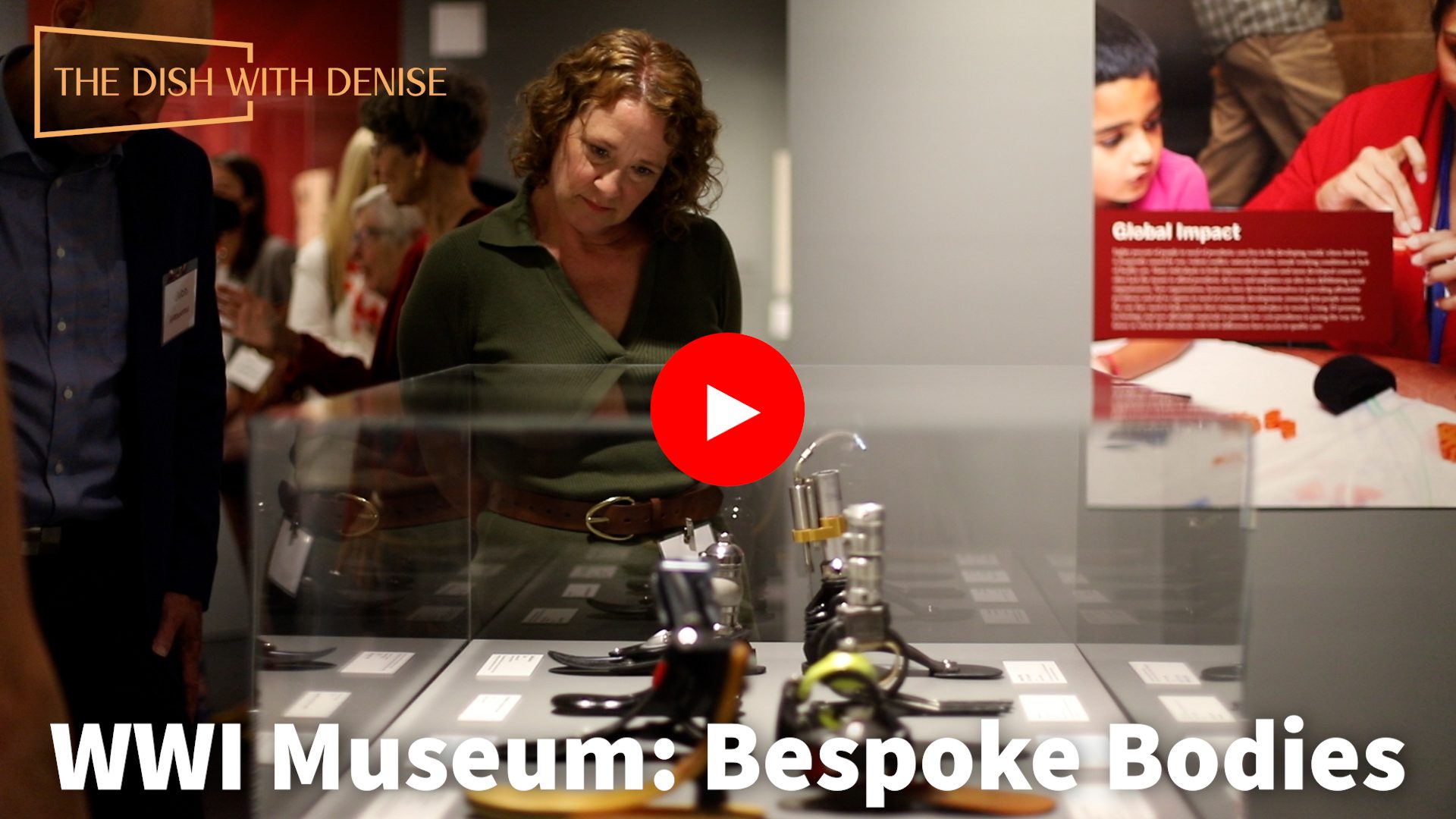 A woman looking at cosmetics in a glass case.